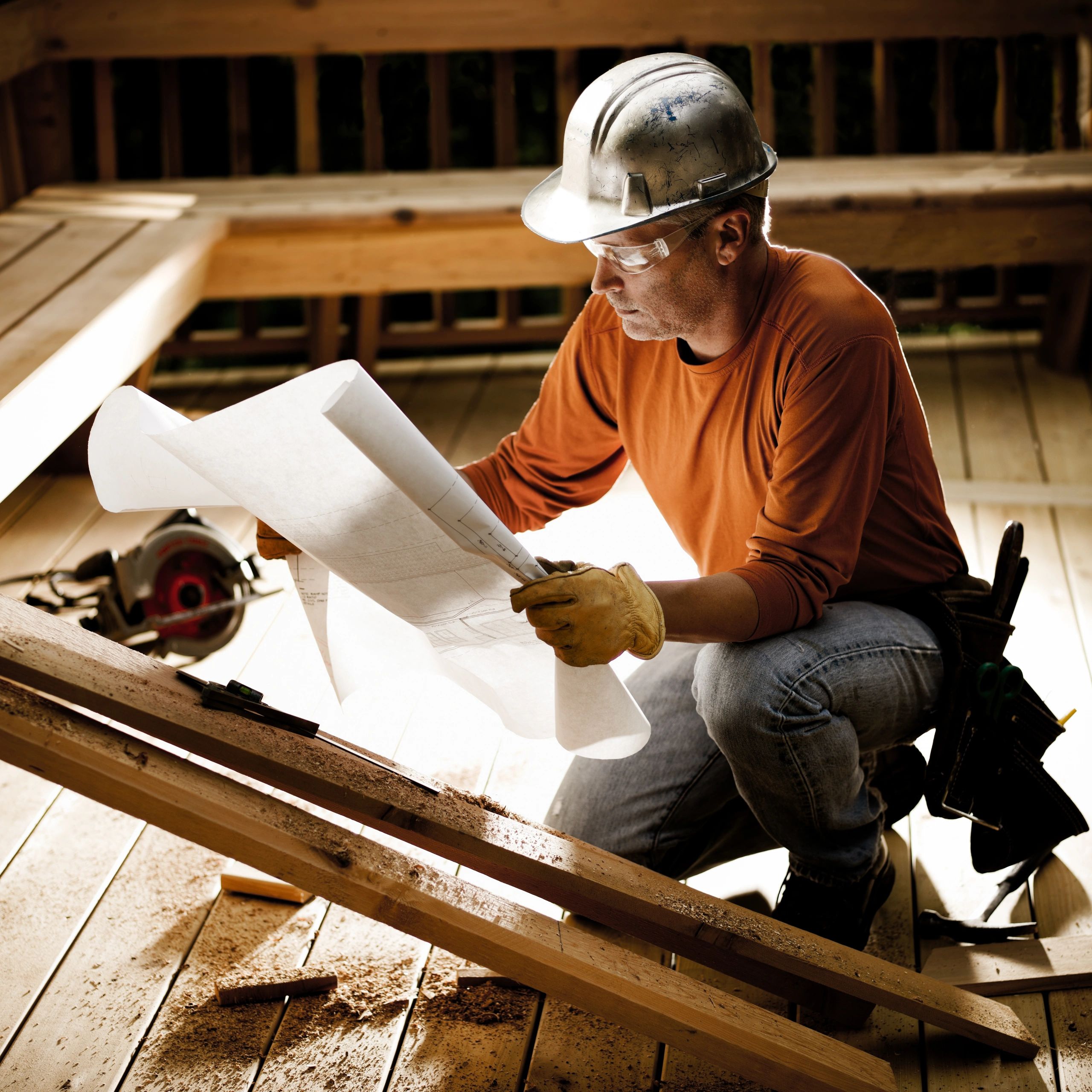 Contractor reviewing plans on site